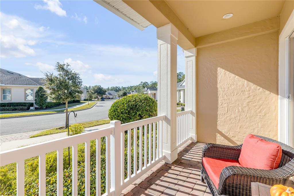 A kitchen with wood cabinets, granite countertops, a center island, and a tile backsplash — 3367 TORRE BOULEVARD, NEW SMYRNA BEACH, FL
