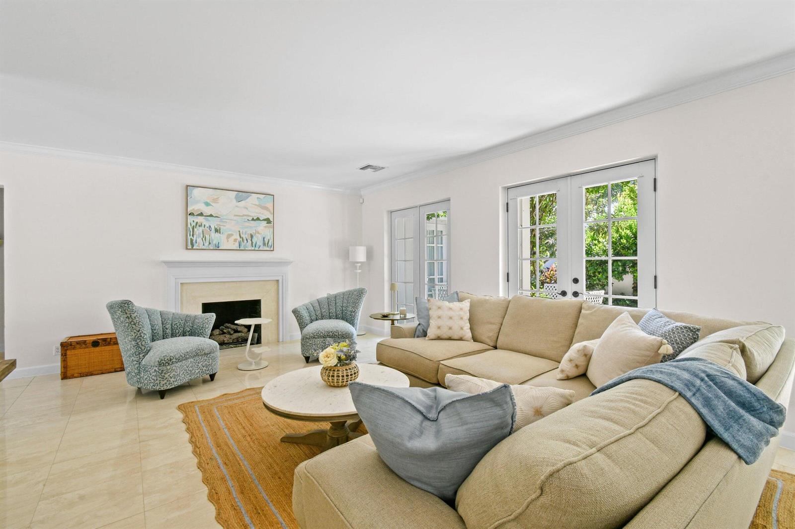 A living room features a fireplace, a beige sectional sofa, two patterned armchairs, and French doors — 117 Via Vizcaya, Palm Beach FL 33480, PALM BEACH, FL