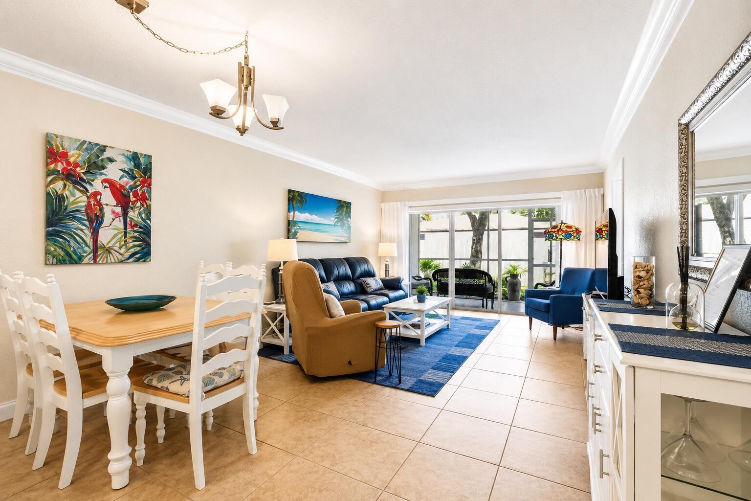 A living and dining room with tile floors, a blue area rug, and patio access — 1501 S Ocean Boulevard # 123, Pompano Beach FL 33062, POMPANO BEACH, FL