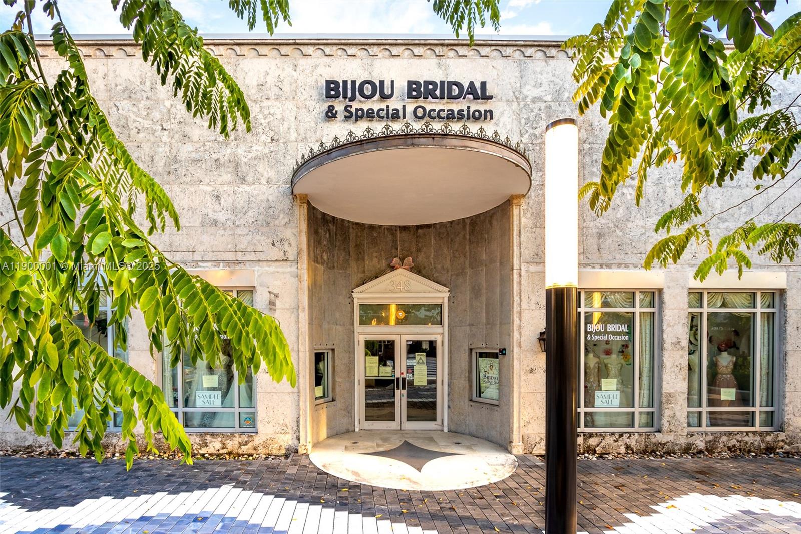 The exterior of a stone building features a recessed entrance and large display windows — 348 Miracle Mile, Coral Gables FL 33134, CORAL GABLES, FL