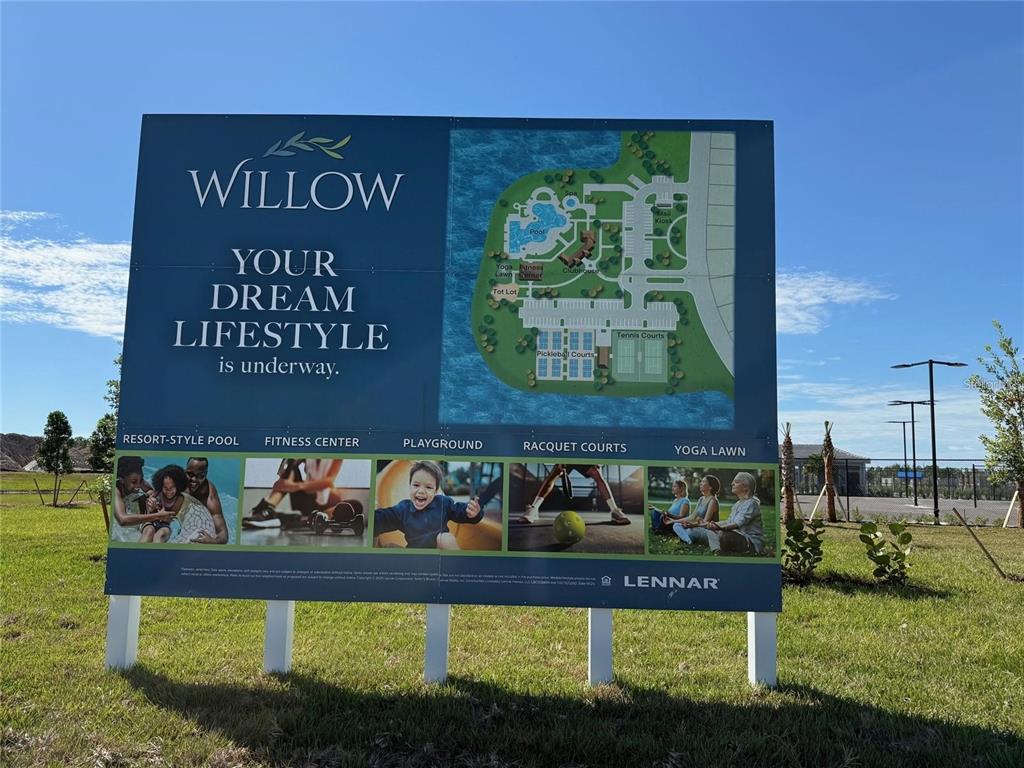 A large outdoor sign displays a site map and amenities for a residential community — 11795 CLOVERLY LANE, PUNTA GORDA, FL
