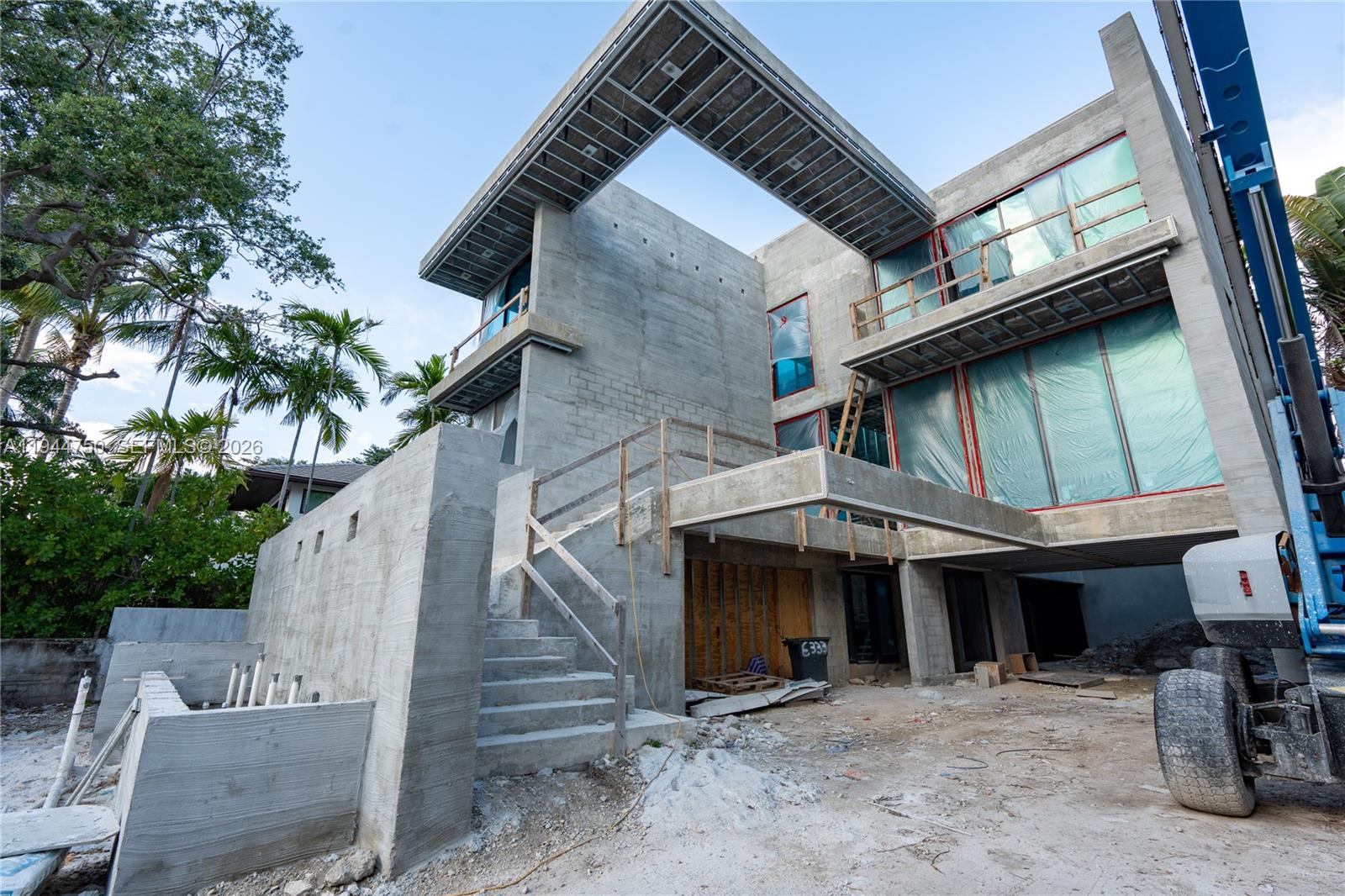 A modern concrete house under construction features a large cantilevered roof and exterior stairs — 333 E Rivo Alto Dr, Miami Beach FL 33139, MIAMI BEACH, FL