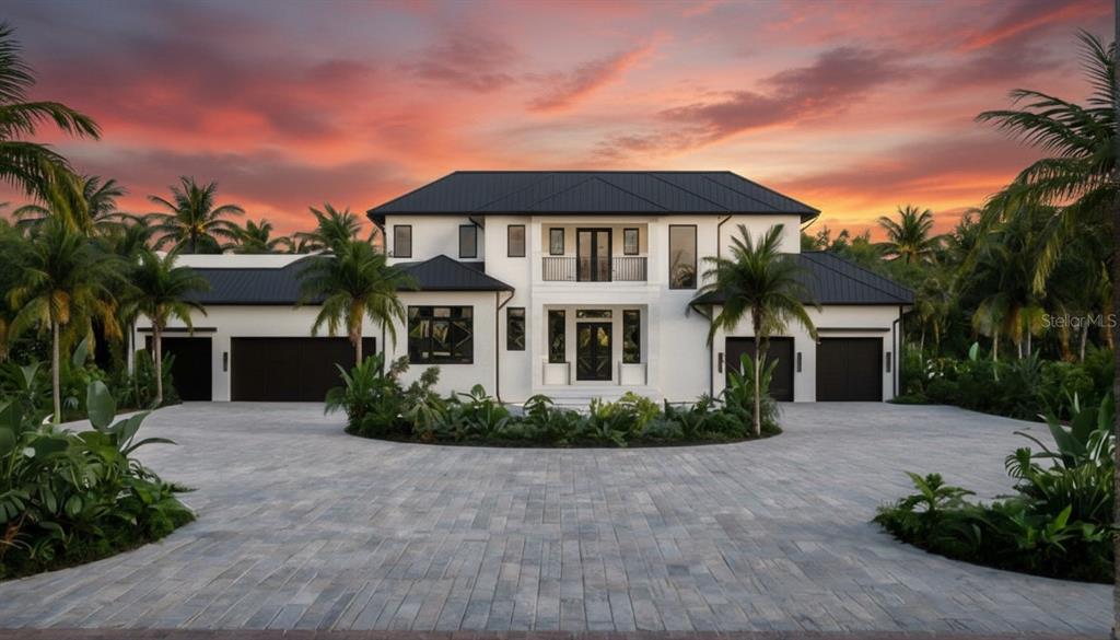 A modern two-story white house with a black metal roof and a paved circular driveway — 1290 HIDDEN HARBOR WAY, SARASOTA, FL