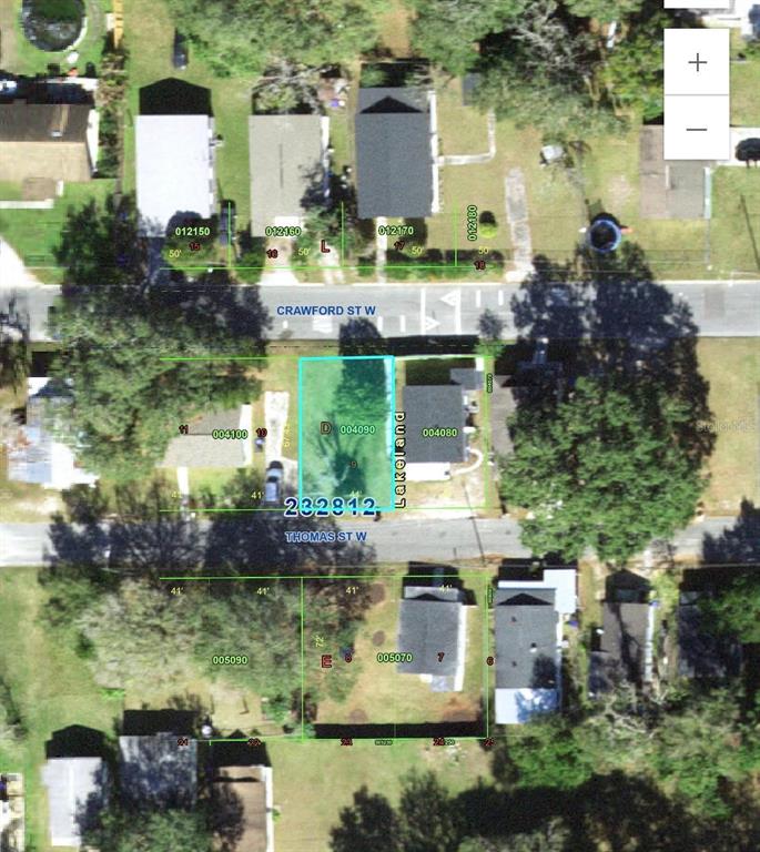 This aerial map shows a vacant residential lot highlighted in blue between two existing houses — THOMAS STREET W, LAKELAND, FL