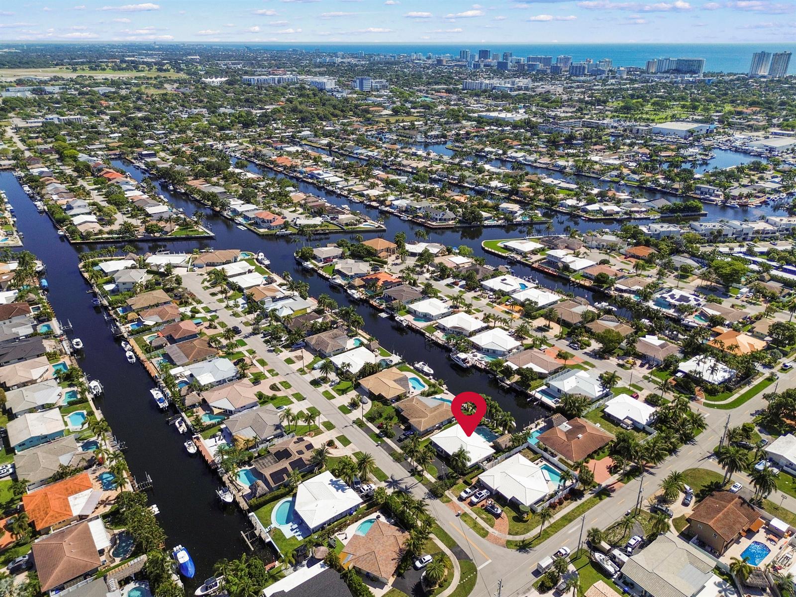 An aerial view shows a residential neighborhood with houses along canals and a red pin — 511 SE 9th Avenue, Pompano Beach FL 33060, POMPANO BEACH, FL