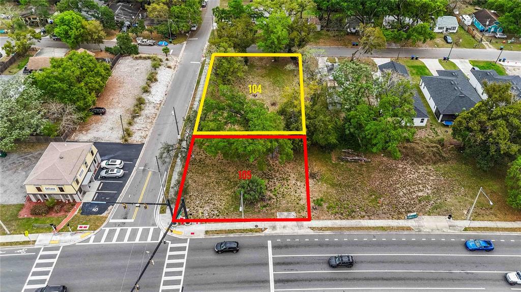 An aerial view shows two adjacent vacant lots outlined in yellow and red near a road — 105 N KIRKMAN RD, ORLANDO, FL