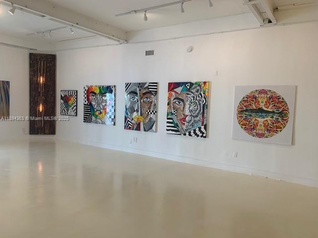 A spacious, minimalist art gallery with white walls, polished concrete floors, and track lighting — 5600 NW 7th Ave, Miami FL 33127, MIAMI, FL