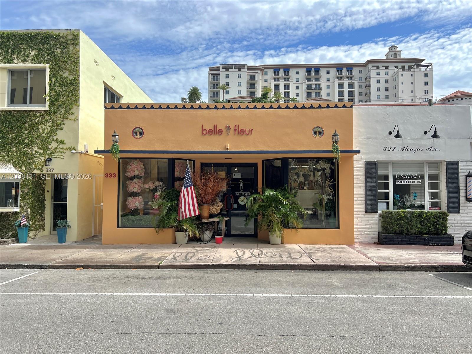 A street-level view shows a peach-colored storefront flanked by a vine-covered building and a white shop — 333 Alcazar Ave, Coral Gables FL 33134, CORAL GABLES, FL