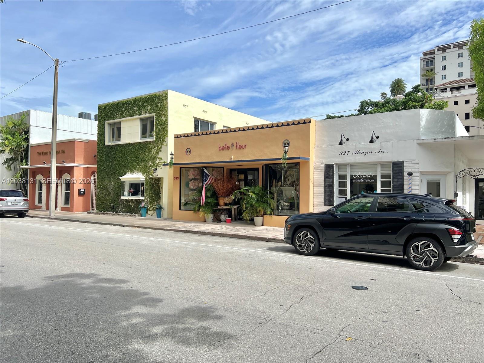 A street-level view shows three adjacent commercial storefronts with a black SUV parked in front — 333 Alcazar Ave, Coral Gables FL 33134, CORAL GABLES, FL