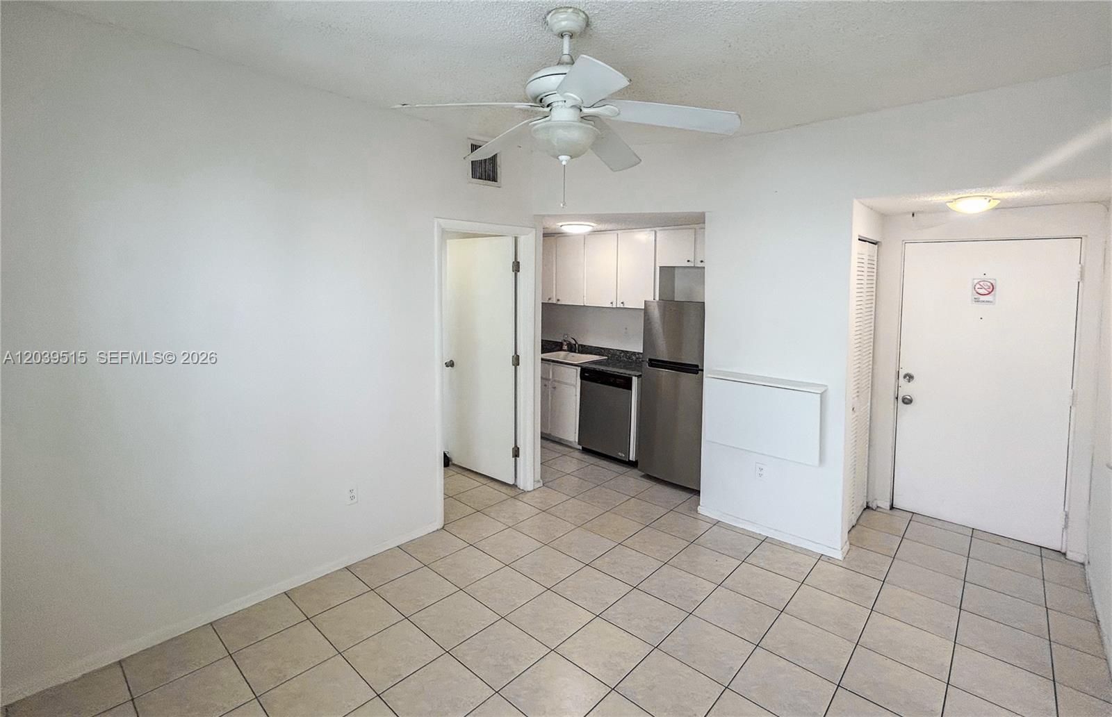 This room features white walls, tile flooring, a ceiling fan, and an adjacent kitchen area — 1218 Drexel Ave # 204, Miami Beach FL 33139, MIAMI BEACH, FL