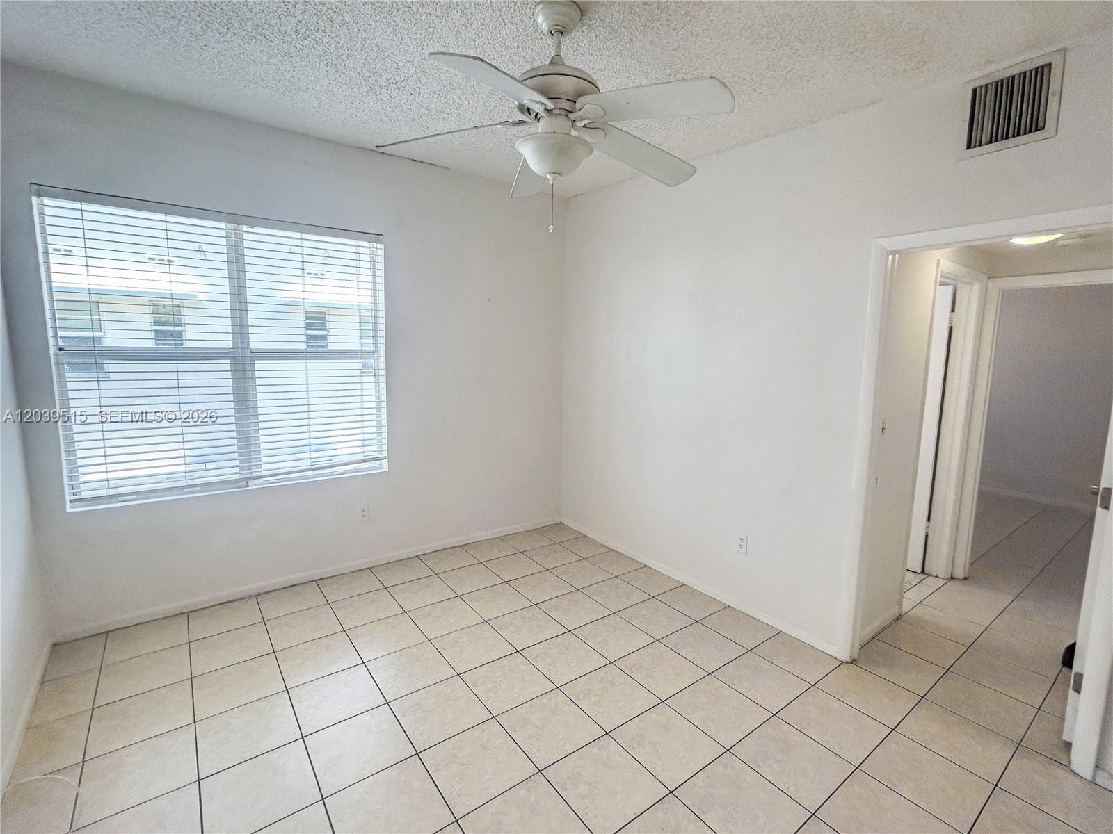 A room with white walls, light-colored tile flooring, a ceiling fan, and a window — 1218 Drexel Ave # 204, Miami Beach FL 33139, MIAMI BEACH, FL