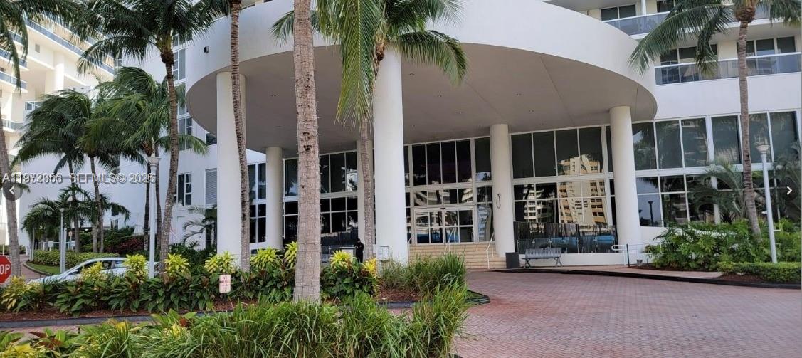The exterior of a multi-story building features a large circular porte-cochère with white columns — 1850 S Ocean Dr # 3007, Hallandale Beach FL 33009, HALLANDALE BEACH, FL