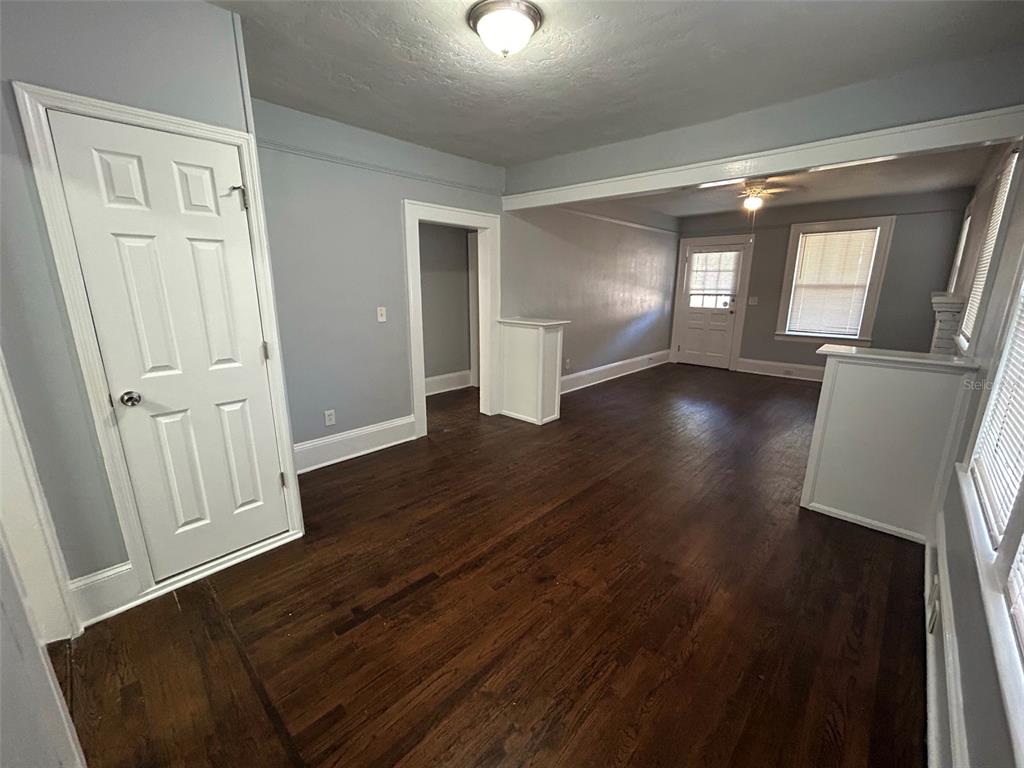 An interior view of a living area with hardwood floors, light gray walls, and doorways — 524 BASSWOOD STREET, JACKSONVILLE, FL