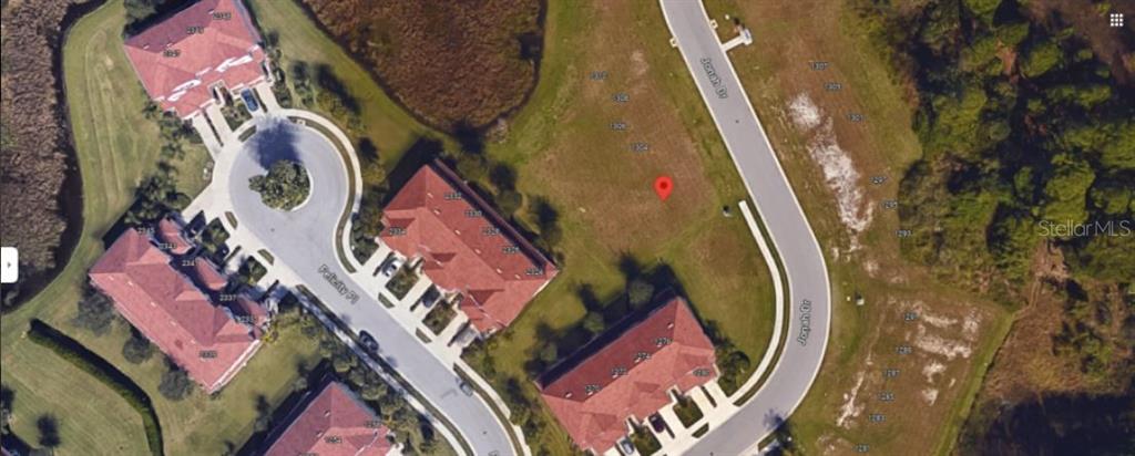 This aerial map shows a residential neighborhood with several buildings and a vacant lot — JONAH DRIVE, NORTH PORT, FL