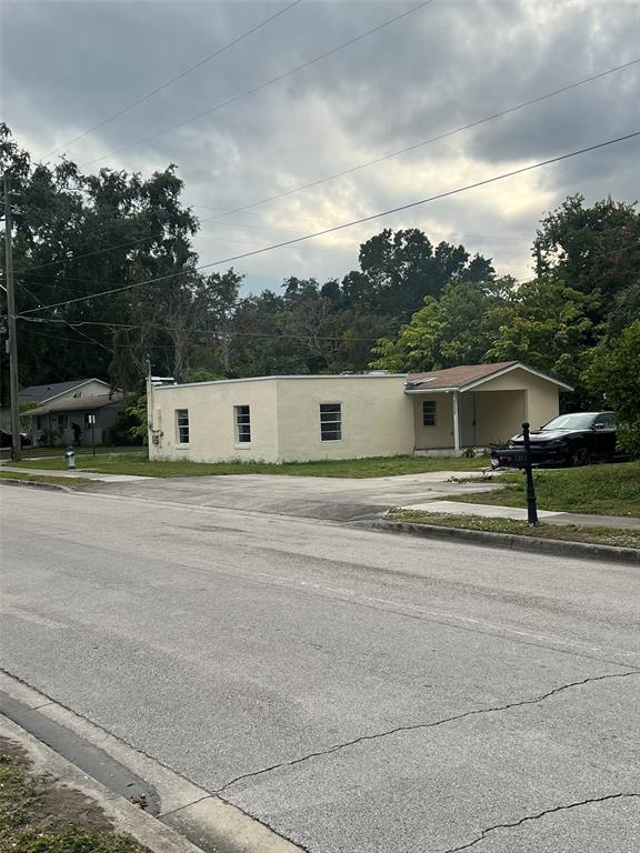 A kitchen features light-colored cabinets, white appliances, marble-look countertops, and wood-style flooring — 2112 LEE STREET, ORLANDO, FL