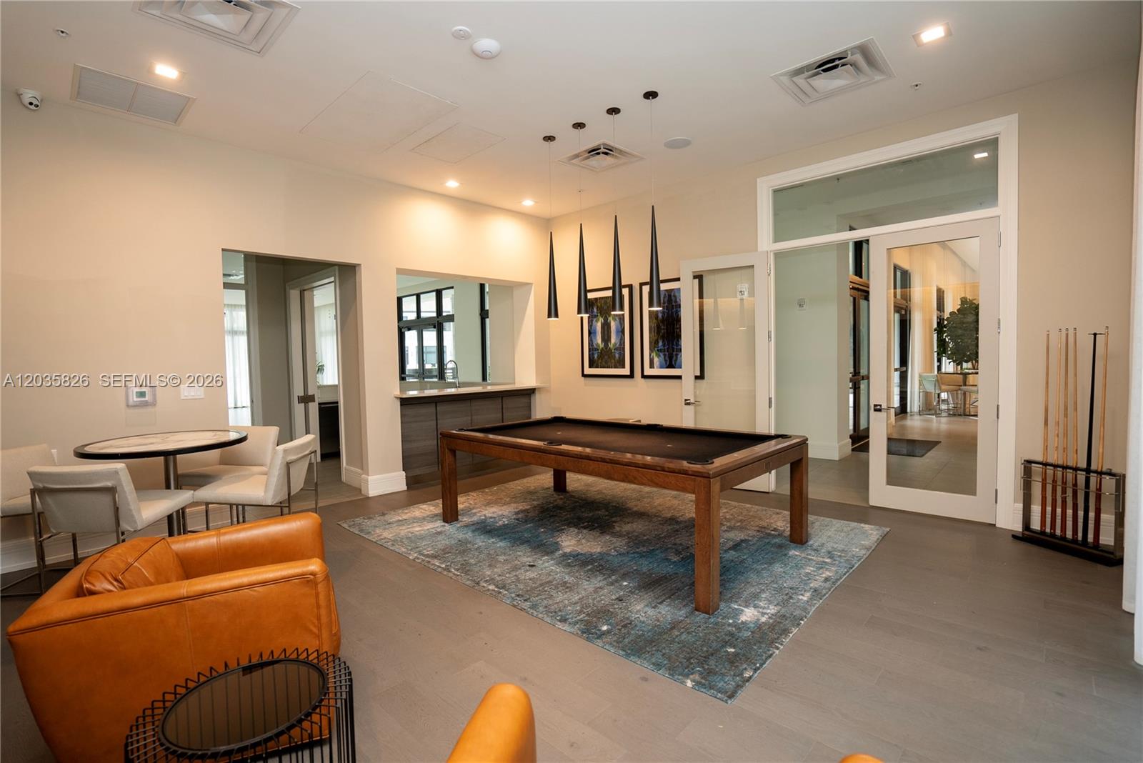 A game room features a pool table, a small bar area, and modern lounge seating — 4740 NW 84th Ct # 32, Doral FL 33166, DORAL, FL