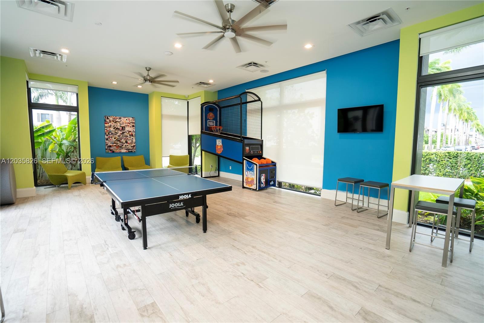 A game room features a ping pong table, basketball arcade game, and blue accent walls — 4740 NW 84th Ct # 32, Doral FL 33166, DORAL, FL
