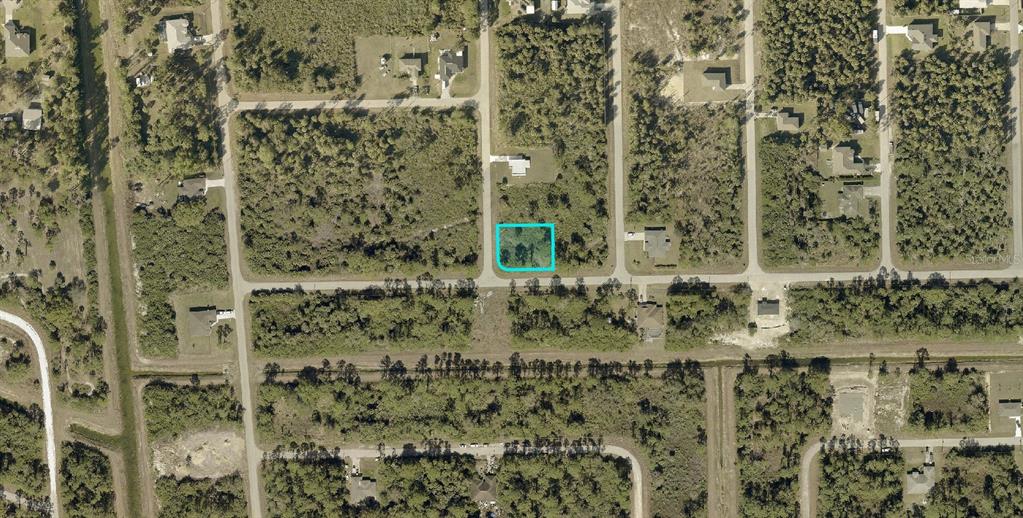 This is an aerial map view of a vacant, rectangular residential lot highlighted in blue — 137 NACELLE AVENUE S, LEHIGH ACRES, FL