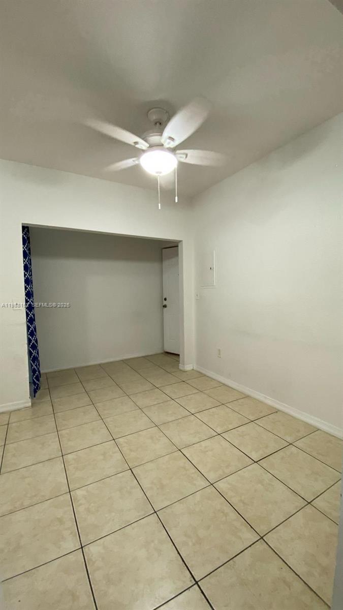 A room with white walls, a ceiling fan, and light-colored tile flooring — 1021 NW 3rd st # 305, Miami FL 33128, MIAMI, FL