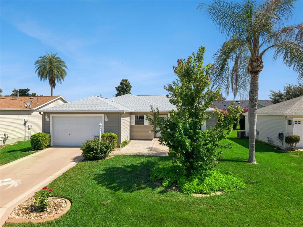 A single-story house with a garage, a paved driveway, and a front yard with trees — 9603 SE 171ST ARGYLL STREET, THE VILLAGES, FL