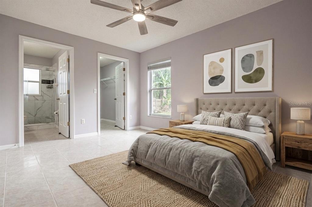 A bedroom with a tufted headboard, ceiling fan, tile floors, and an attached bathroom — 5437 LEHIGH AVENUE, ORLANDO, FL