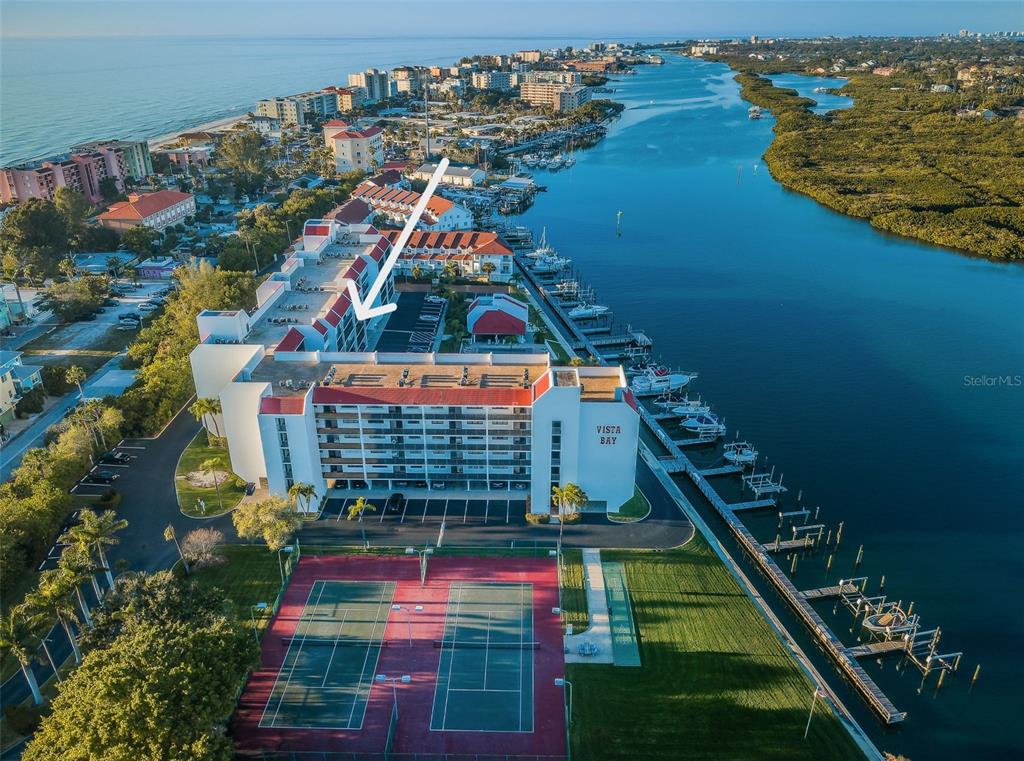 An aerial view shows the Vista Bay condominium complex with tennis courts and boat slips — 19111 VISTA BAY DRIVE UNIT 304, INDIAN SHORES, FL