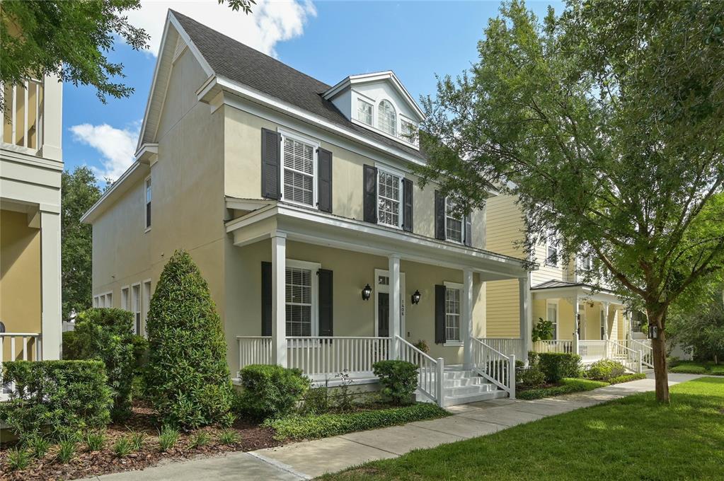 A two-story house with a front porch, black shutters, and a dormer window — 1406 NOLAN COURT, ORLANDO, FL