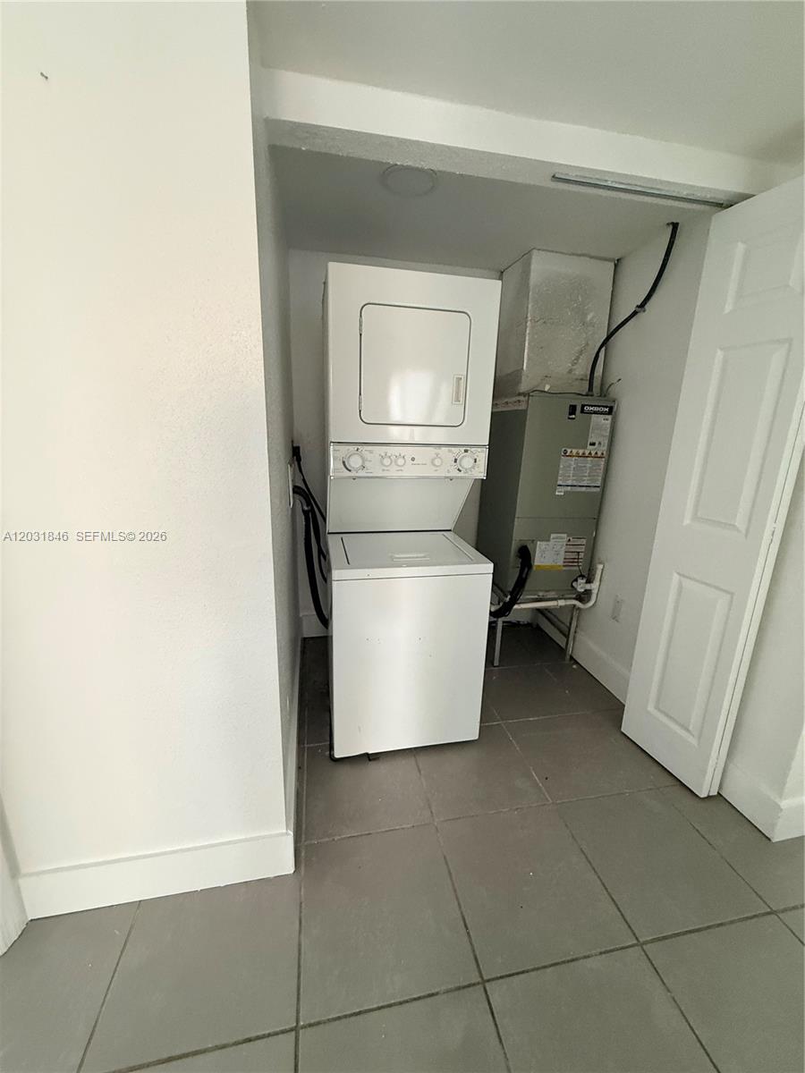 A laundry closet contains a stacked washer-dryer unit and an HVAC air handler — 7824 NW 5th Ct # 7, Miami FL 33150, MIAMI, FL