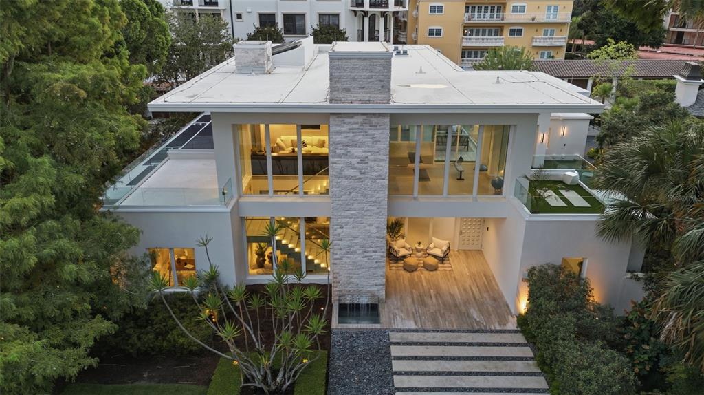 An aerial view of a modern two-story house with a stone chimney and flat roof — 229 ALEXANDER PLACE, WINTER PARK, FL