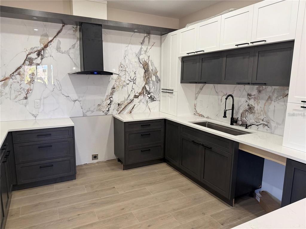 An open-concept living area features light wood-look flooring, recessed lighting, and sliding glass doors — 47 BRIG CIRCLE E, PLACIDA, FL