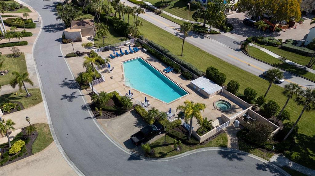 An aerial view shows a rectangular swimming pool, a hot tub, and lounge chairs — 2013 HARBOUR LINKS DRIVE UNIT 2013, LONGBOAT KEY, FL