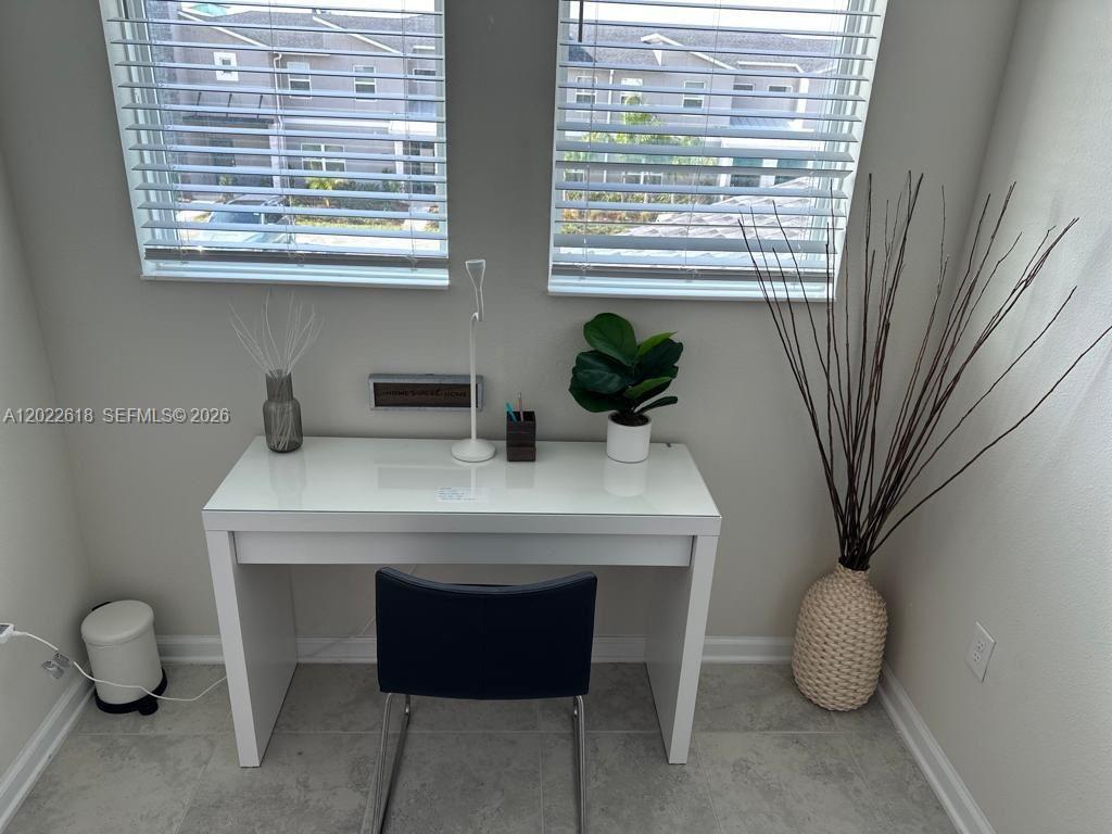 A white desk sits in front of two windows in a room with tiled floors — 1171 CHALLENGE DR # 1171, Davenport FL 33896, DAVENPORT, FL