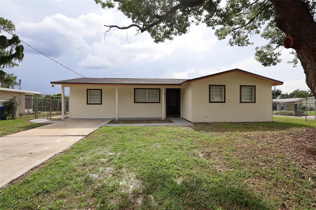 A single-story house with a beige exterior, a concrete driveway, and a front porch — 505 CLEARFIELD ROAD, BRANDON, FL