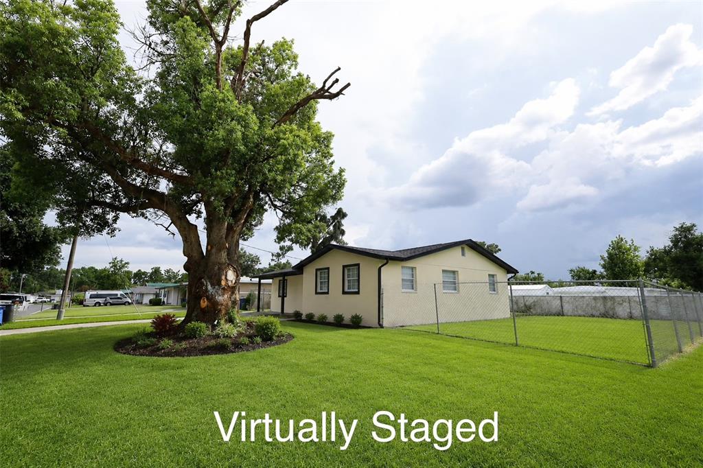 A single-story house with a large tree in the front yard and a chain-link fence — 505 CLEARFIELD ROAD, BRANDON, FL
