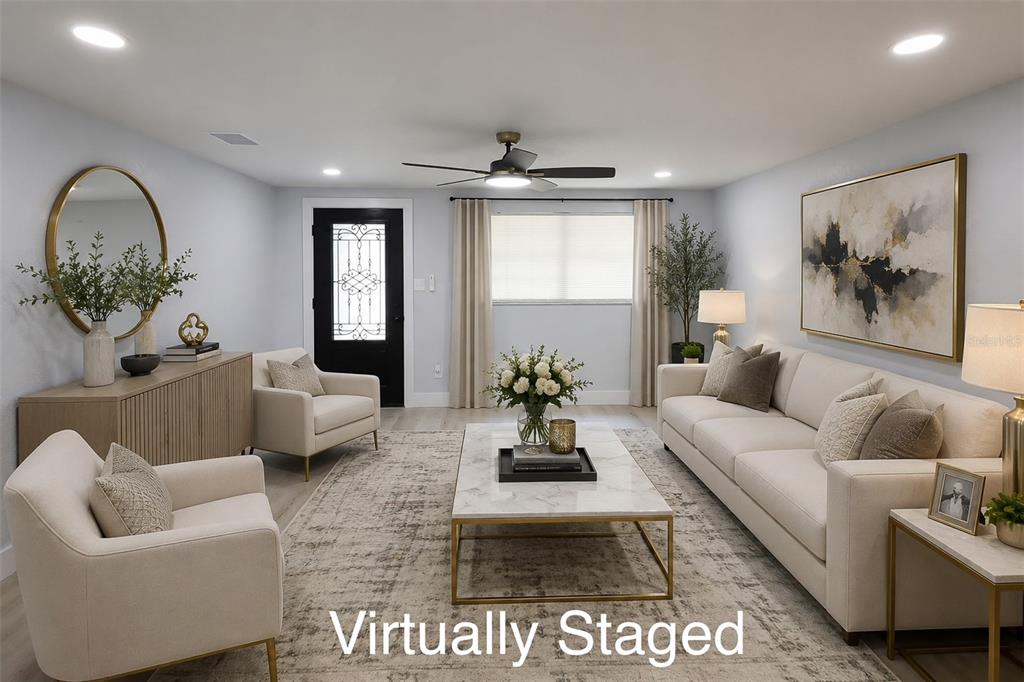 A living room features a white sofa, two armchairs, a marble coffee table, and decor — 505 CLEARFIELD ROAD, BRANDON, FL