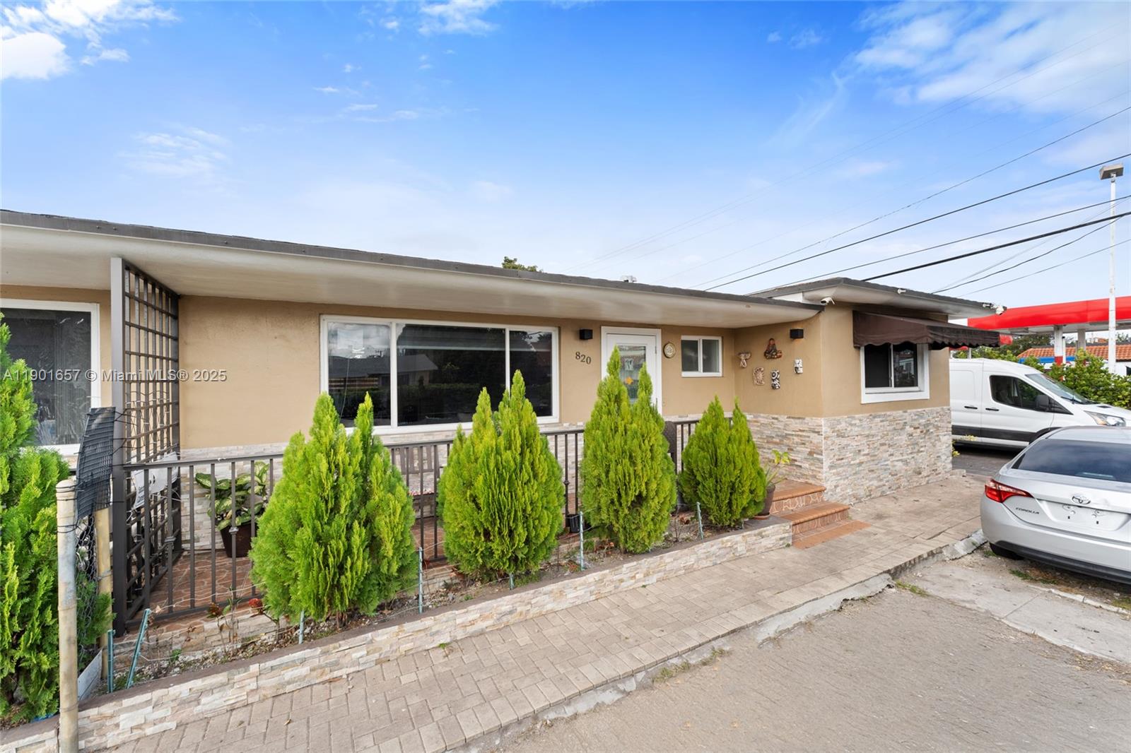 The exterior of a single-story house features a stone-veneer base, a front porch, and landscaping — 820 SW 17th Ave # 1, Miami FL 33135, MIAMI, FL