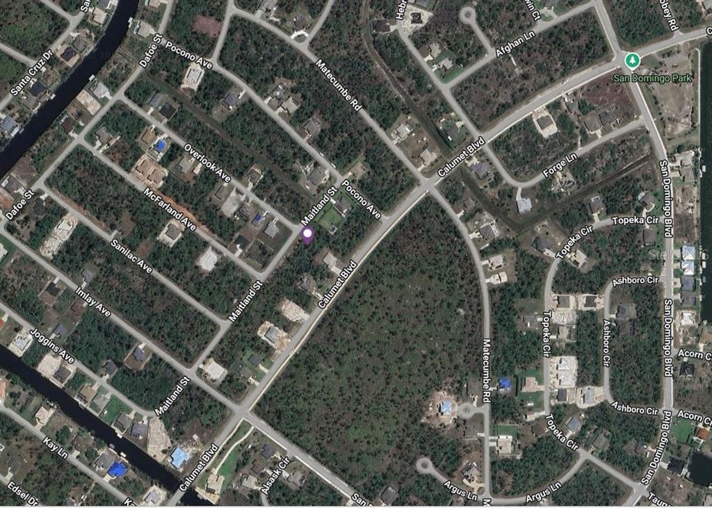 This is an aerial map view of a residential neighborhood with streets and wooded lots — 8386 MAITLAND STREET, PORT CHARLOTTE, FL