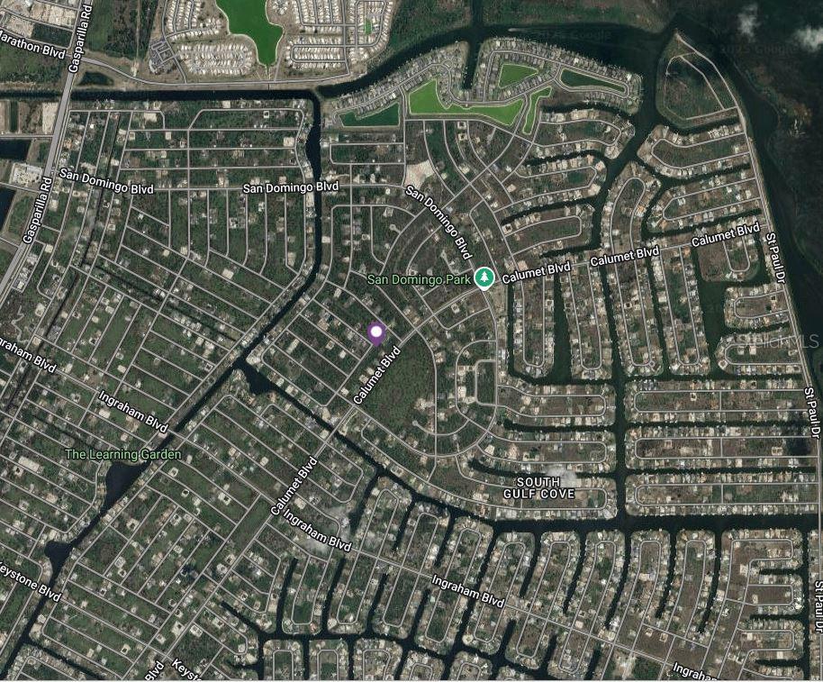 This is an aerial map view of a residential neighborhood with canal-front properties — 8386 MAITLAND STREET, PORT CHARLOTTE, FL