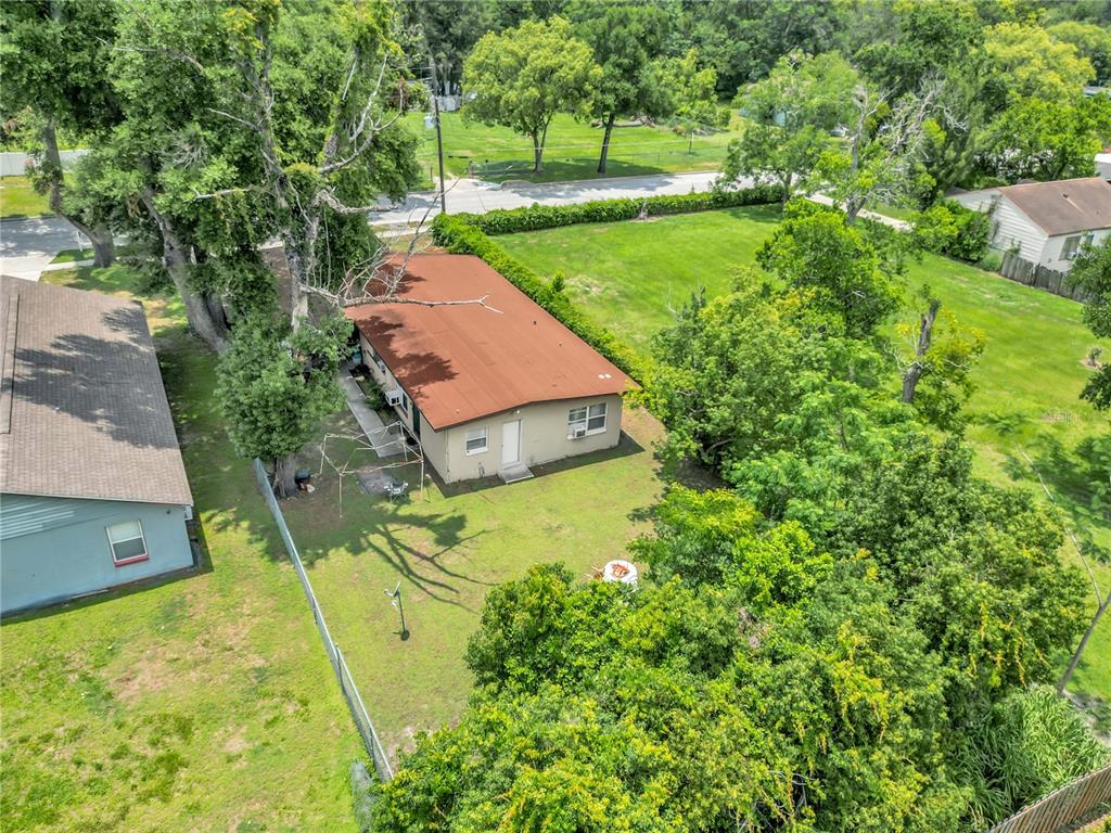 An aerial view shows a single-story house with a brown roof on a grassy lot — 1113 S LEE AVENUE, ORLANDO, FL