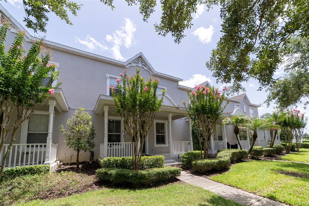 A row of two-story townhomes with gray siding, front porches, and manicured landscaping — 3933 CLEARY WAY, ORLANDO, FL
