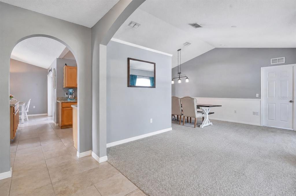 A single-story house with a gray exterior, a garage, and a front walkway — 132 ZACHARY WADE STREET, WINTER GARDEN, FL