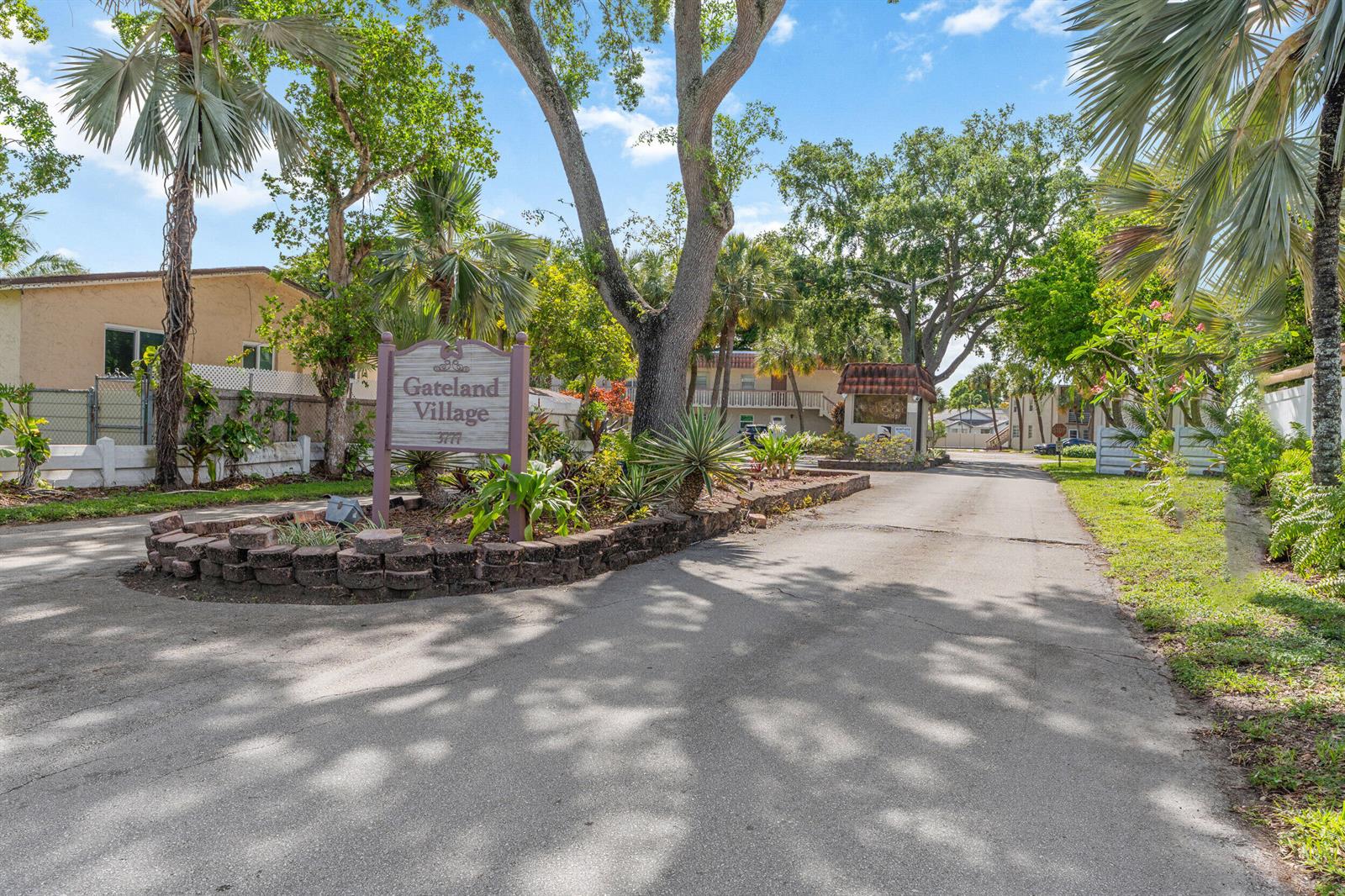 A sign for Gateland Village stands at the entrance of a paved residential driveway — 3777 NW 78th Avenue # 1b, Davie FL 33024, DAVIE, FL