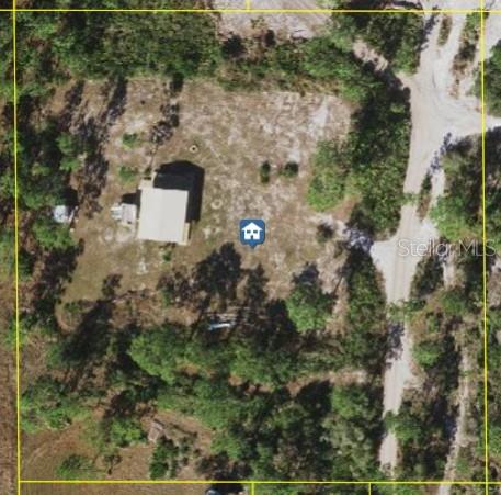 This aerial map view shows a house on a wooded lot with a dirt driveway — HOLOPAW GROVES ROAD, ST CLOUD, FL