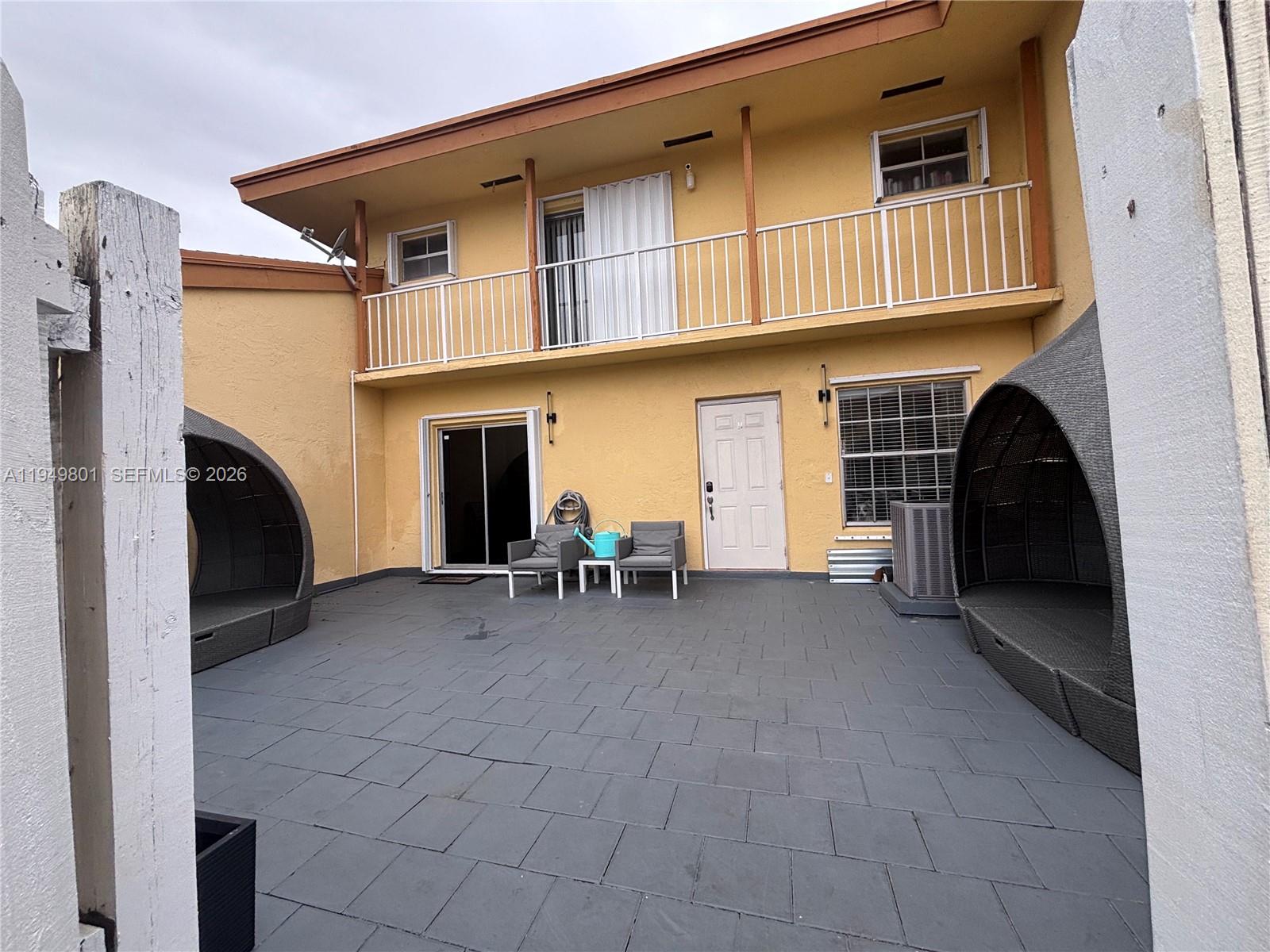 A paved patio features two outdoor lounge chairs, a small table, and two hooded chairs — 8384 SW 154th Ave # 68, Miami FL 33193, MIAMI, FL