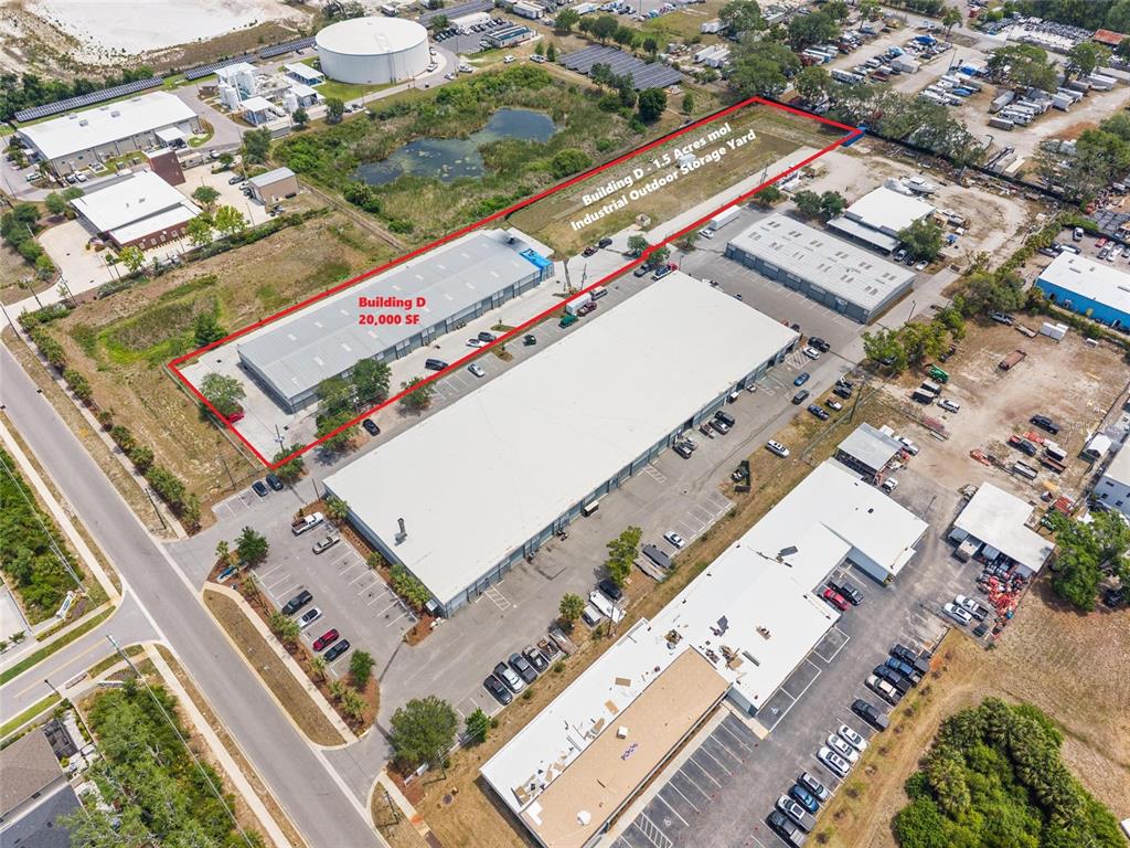 An aerial view shows industrial buildings with parking lots and an outdoor storage yard — 1500 L AND R INDUSTRIAL BOULEVARD Bldg. D, TARPON SPRINGS, FL