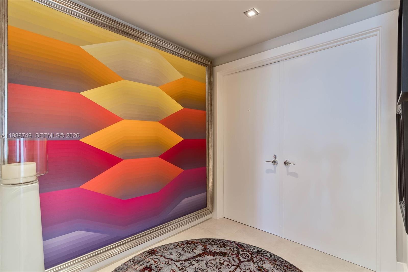 A foyer features a large abstract geometric painting, double white doors, and a circular rug — 3737 Collins Ave # 203, Miami Beach FL 33140, MIAMI BEACH, FL