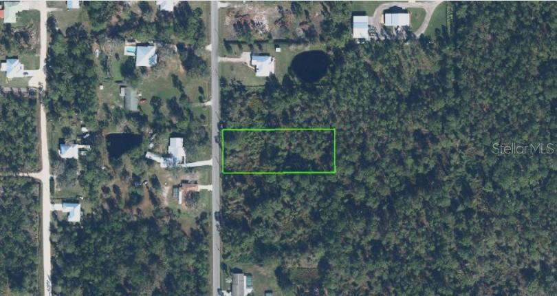An aerial view shows a rectangular plot of land outlined in green next to a road — 6016 GOLDEN ROAD, SEBRING, FL