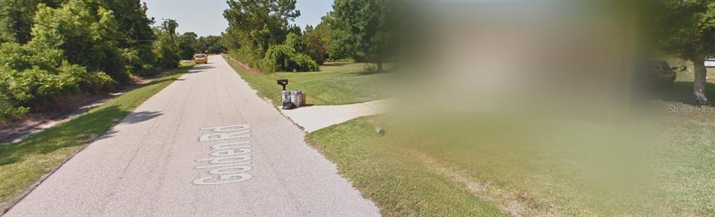 A paved road named Golden Rd runs past a grassy lot with a mailbox — 6016 GOLDEN ROAD, SEBRING, FL