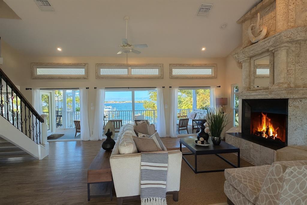 A multi-story house with a pool, patio, and illuminated balconies at dusk — 255 46TH AVENUE, ST PETE BEACH, FL
