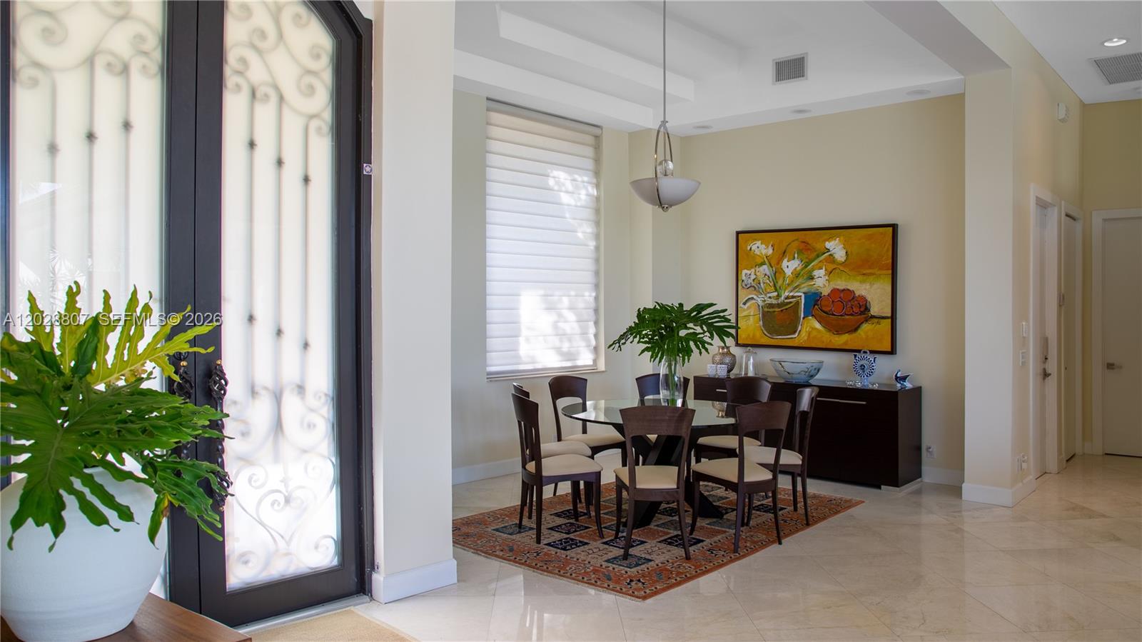 A dining area features a glass table, six chairs, a rug, and a wall painting — 2880 Windmill Ranch Rd, Weston FL 33331, WESTON, FL